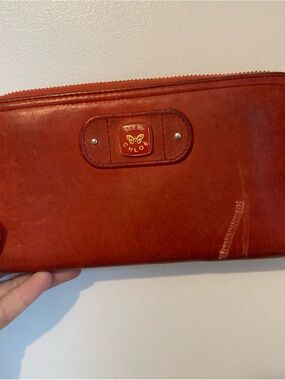 See By Chloe red leather zip-around wallet with gold logo some damage on front